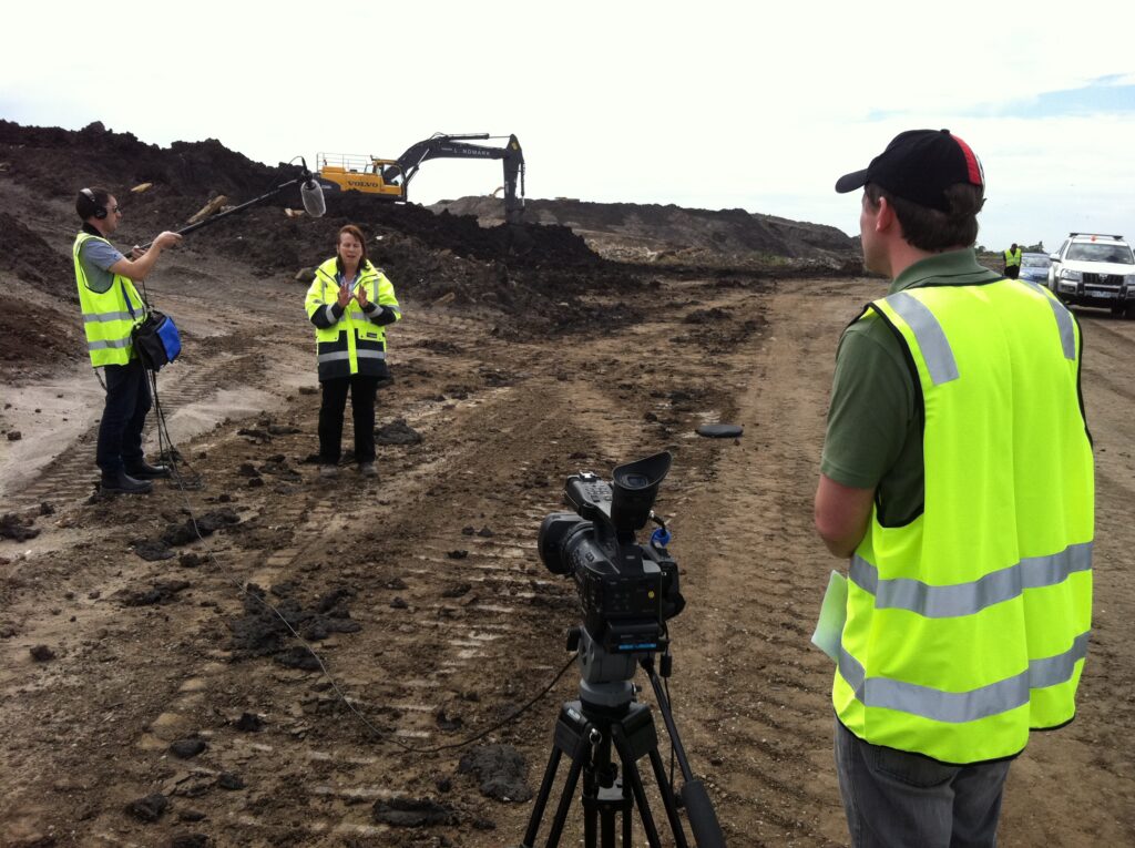 video camera crew doing an interview in an. industrial site