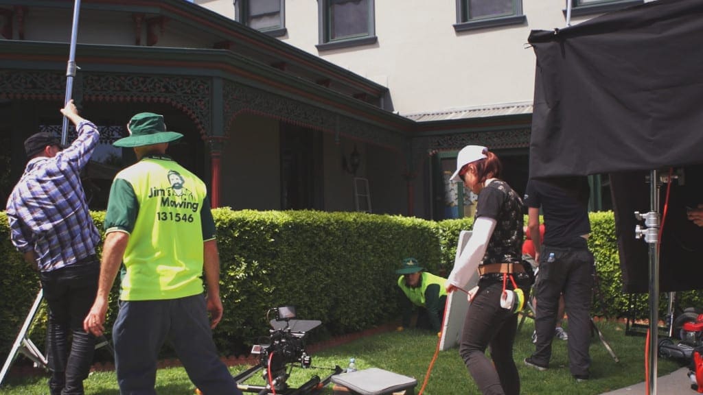 Dream Engine crew and Jim’s Mowing performer working on the outdoor TV commercial