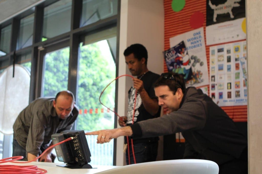 Ryan Spanger and a Dream Engine camera crew reviewing a take on the production monitor