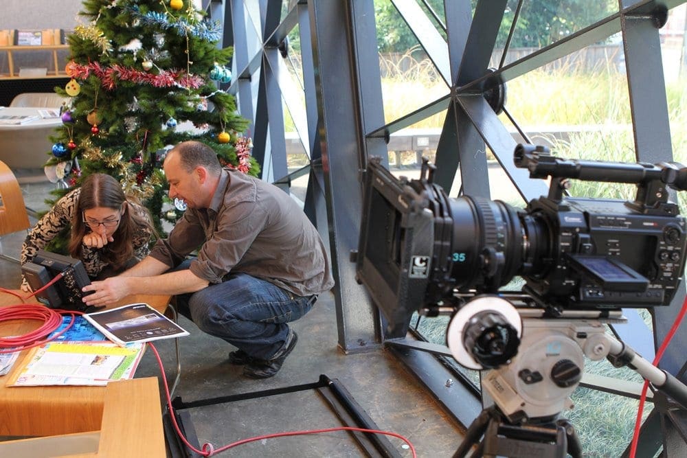Dream Engine working with a client beside the camera during a video shoot