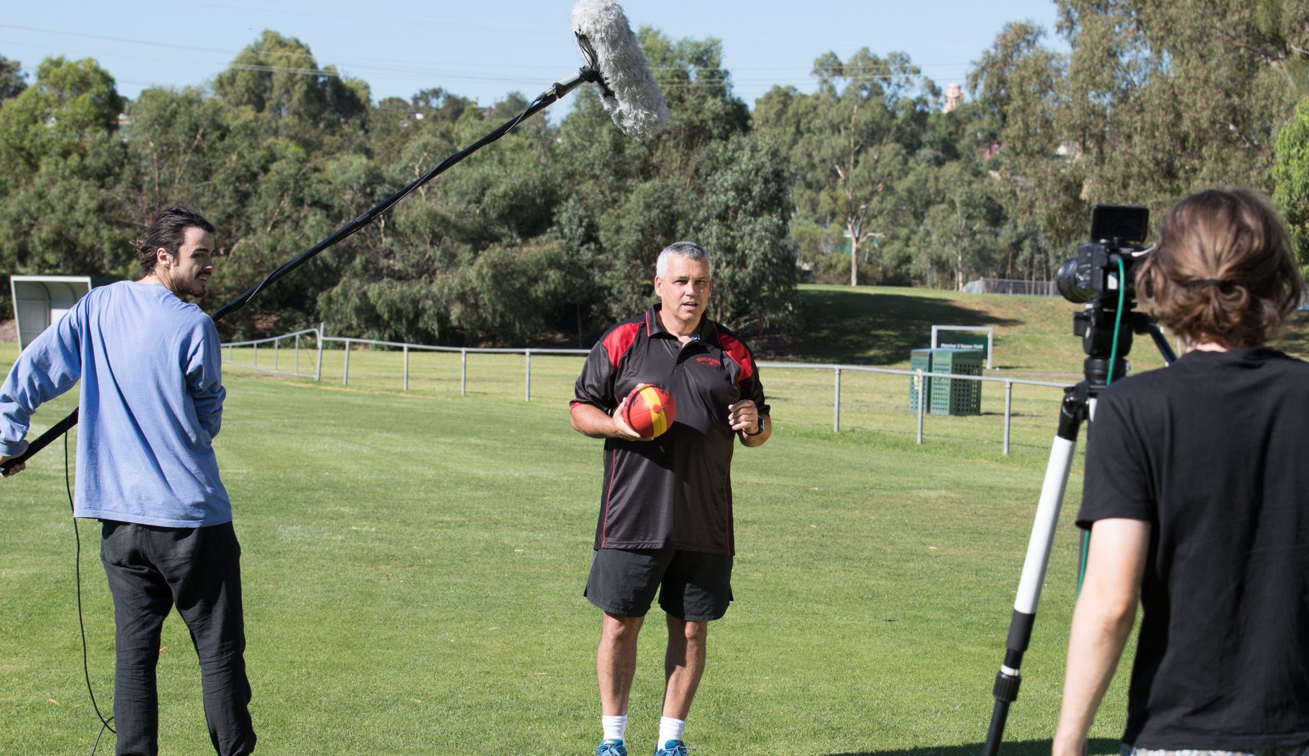 Dream Engine camera and sound crew filming a football coach on location