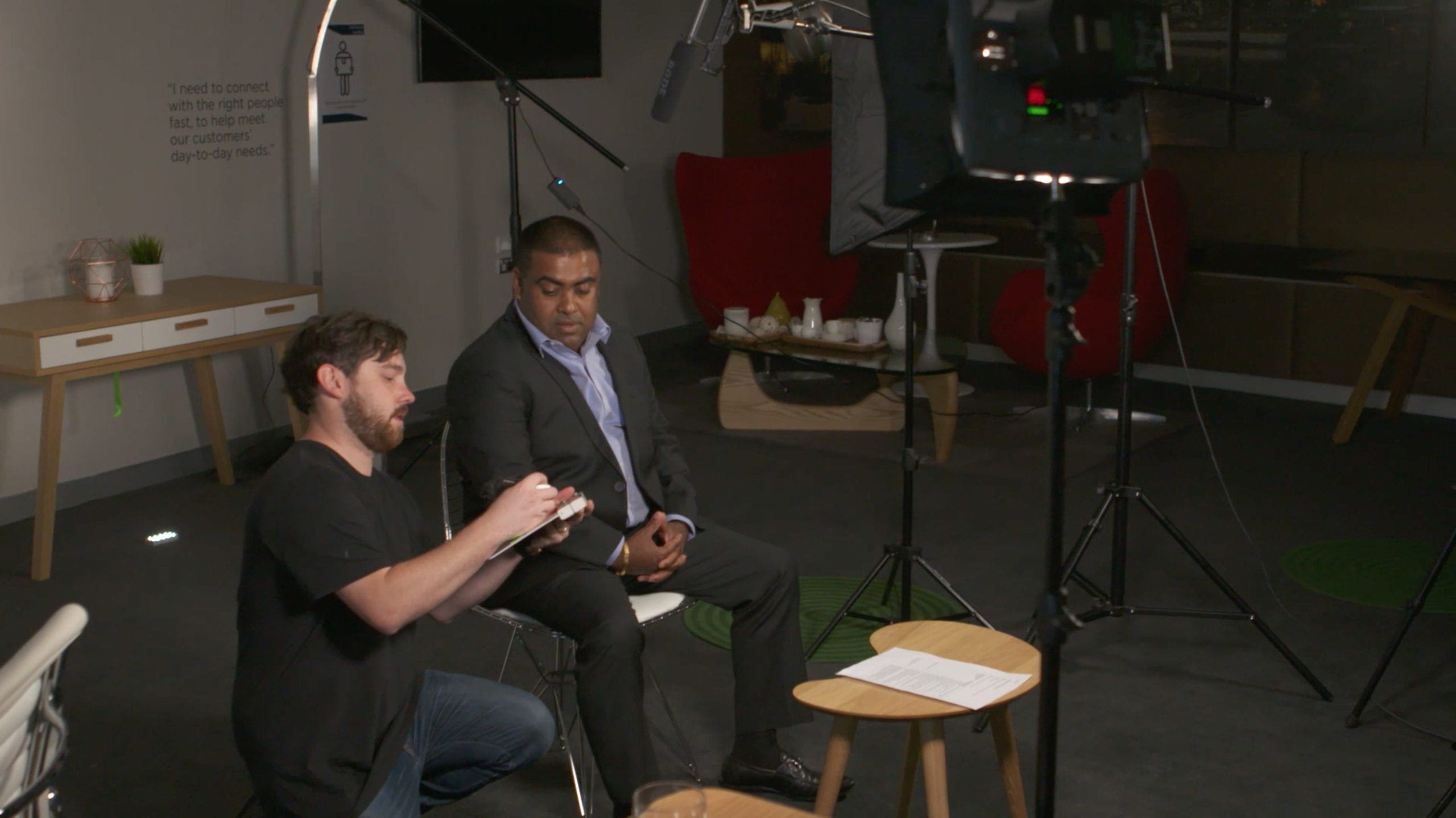 Dream Engine director reviewing the script with a corporate presenter before filming