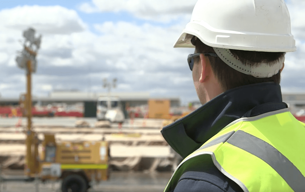 man wearing safety hat in a construction video