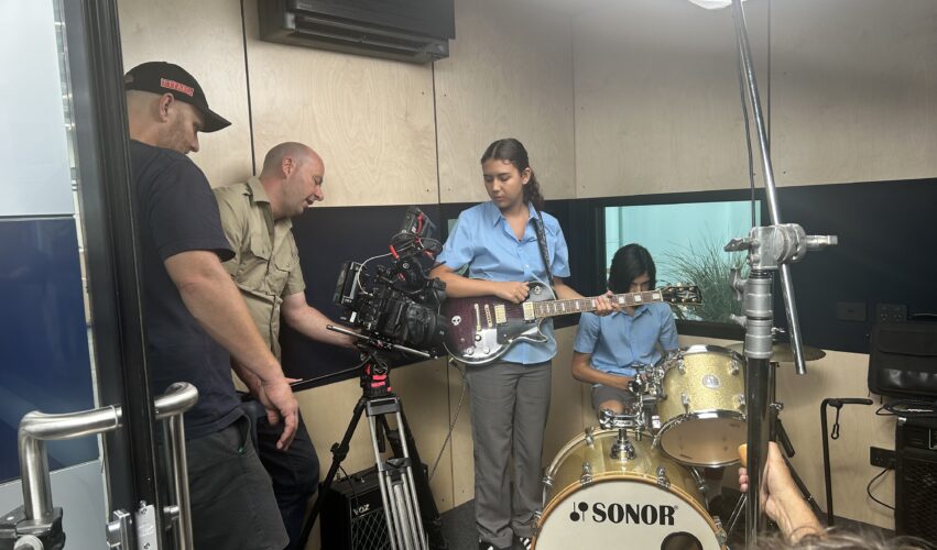camera crew filming a band