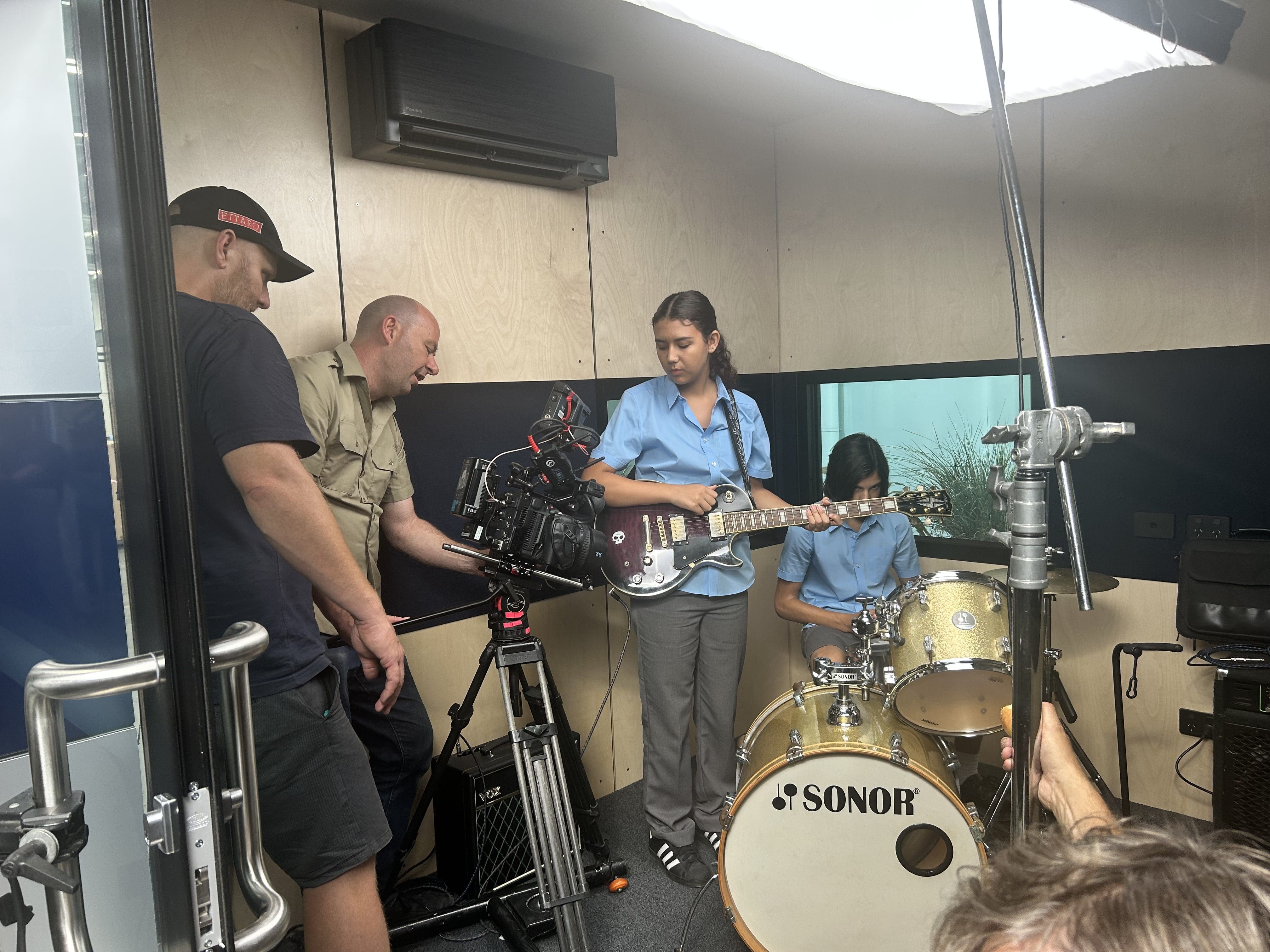 Dream Engine crew filming students performing music for a school video