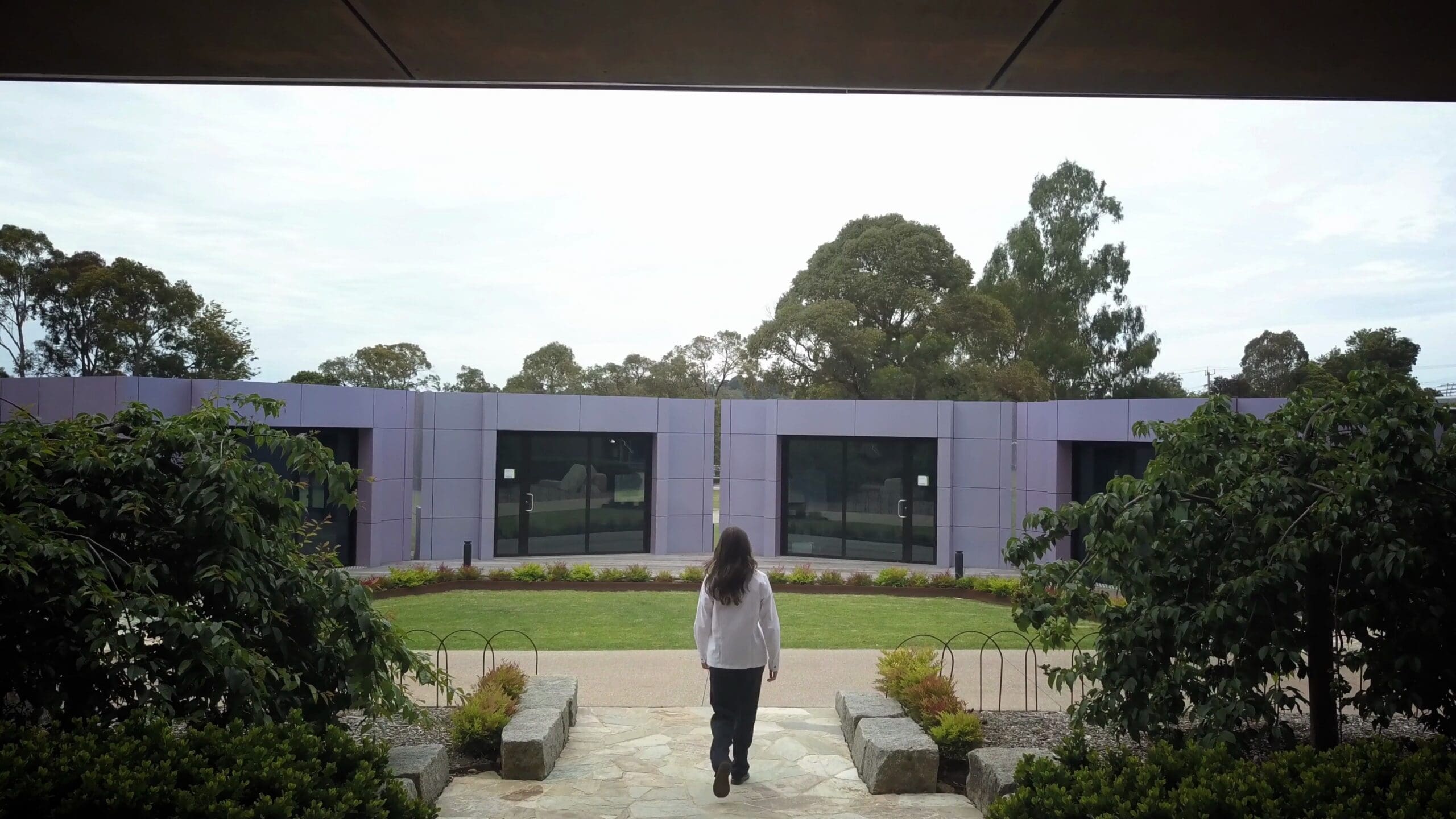 Student walking towards Harwyn music pods installed at a school