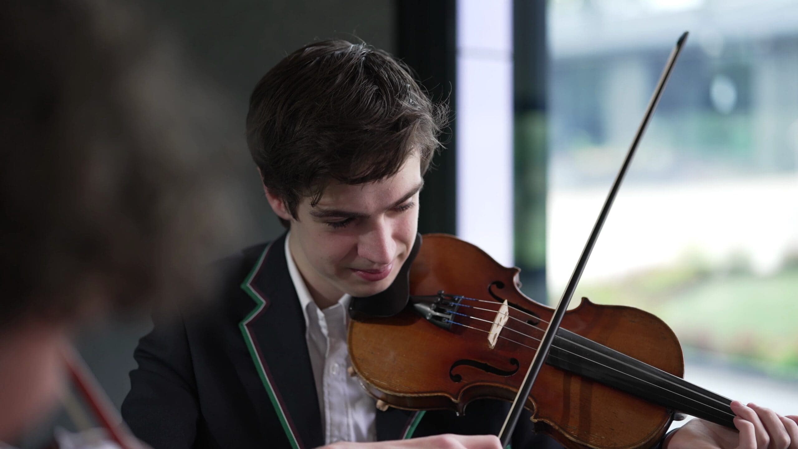 Student violinist performing inside a Harwyn music pod