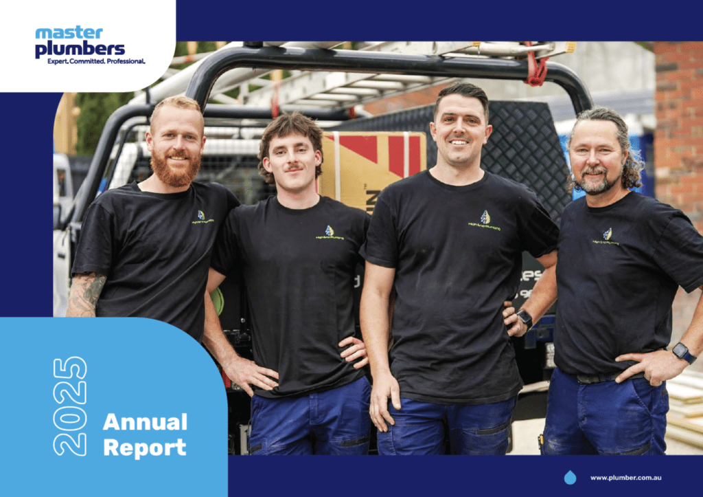 Four plumbers standing in front of a truck