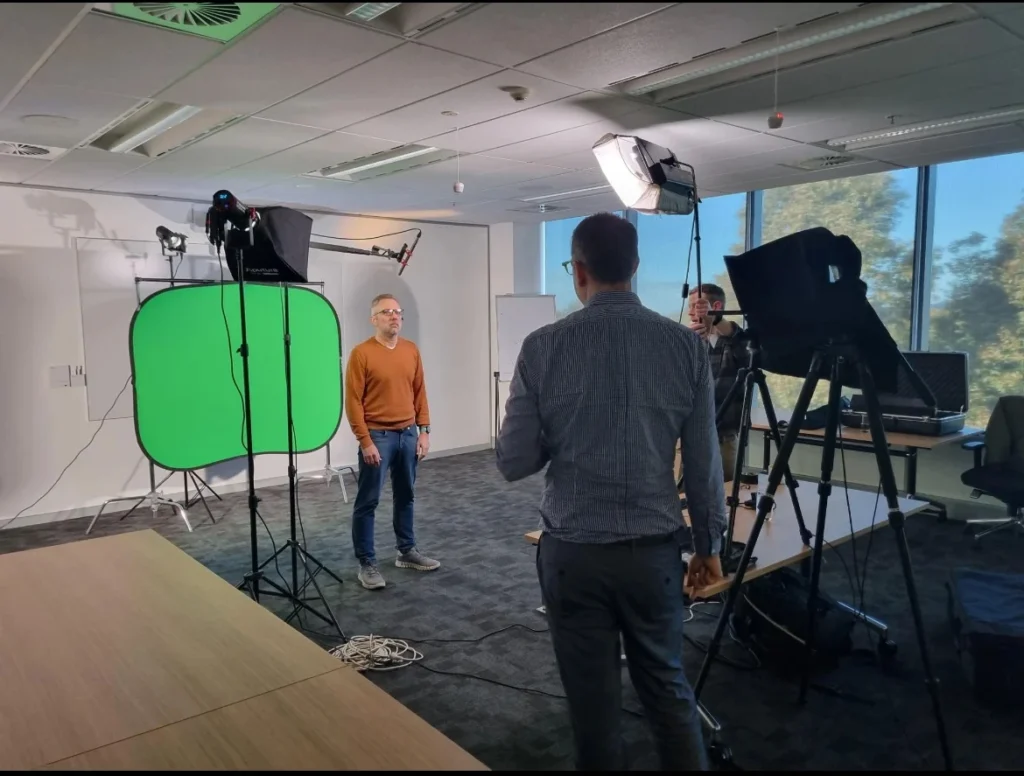 person being filmed in front of a green screen