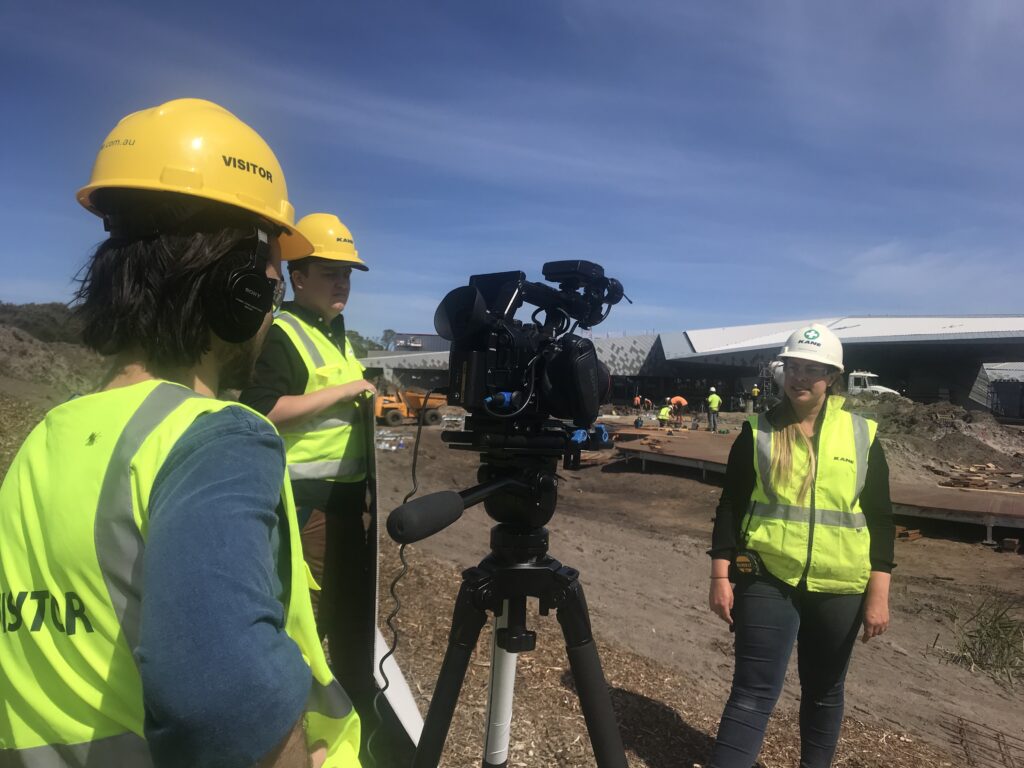 camera crew filming an interview outside