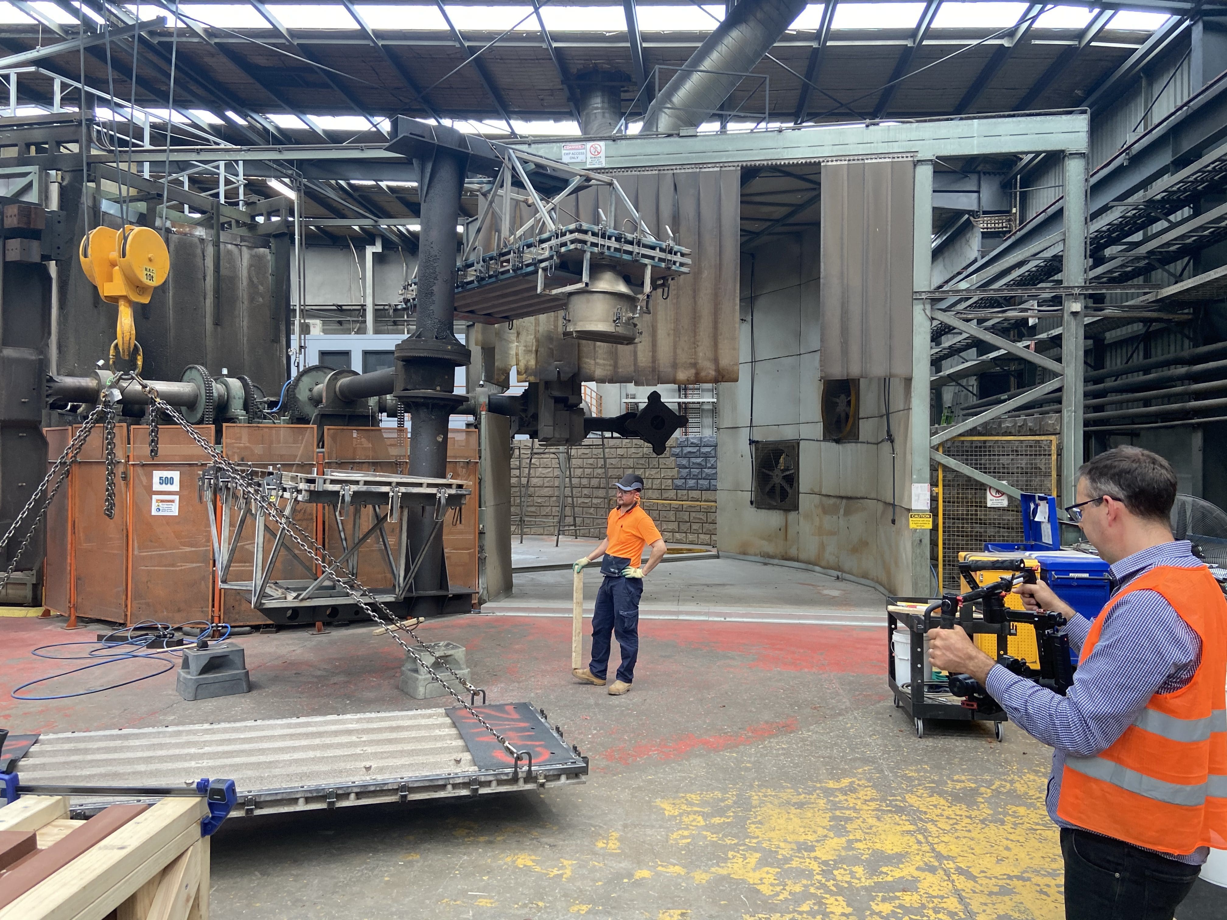 Dream Engine camera operator filming inside an industrial factory after planning access and safety requirements