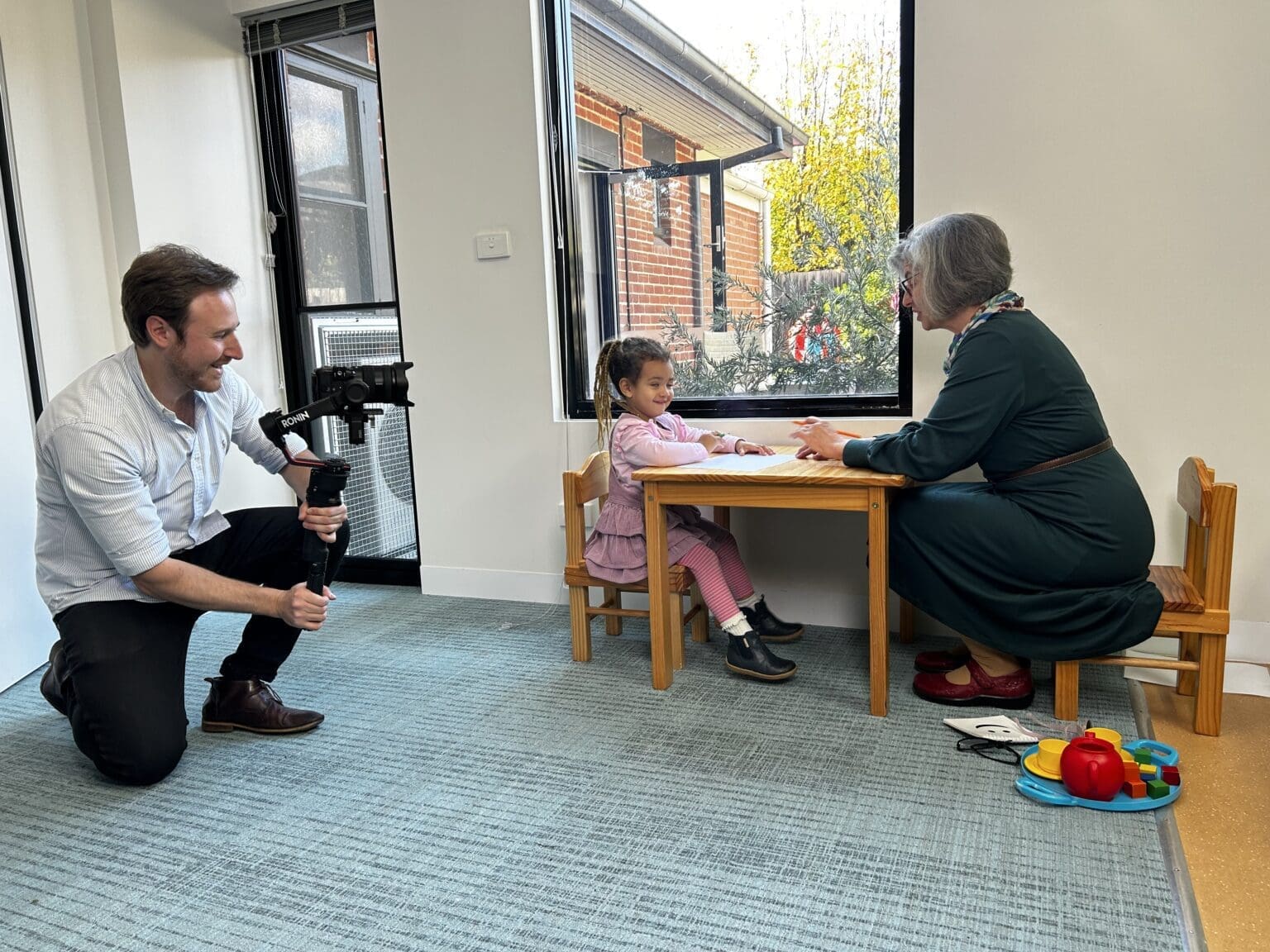 Dream Engine camera operator filming genuine workplace activity with participants