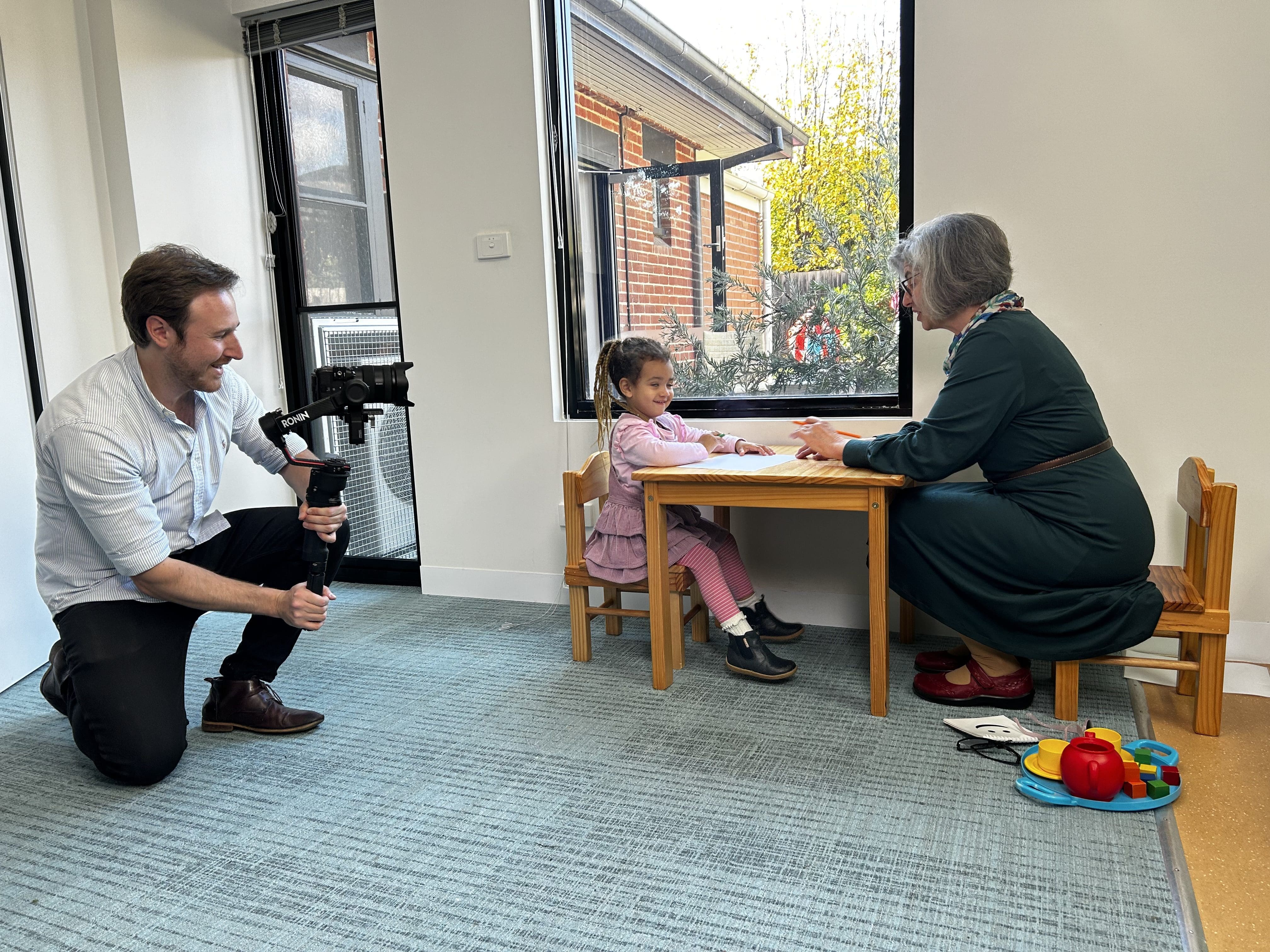 Dream Engine camera operator filming genuine workplace activity with participants