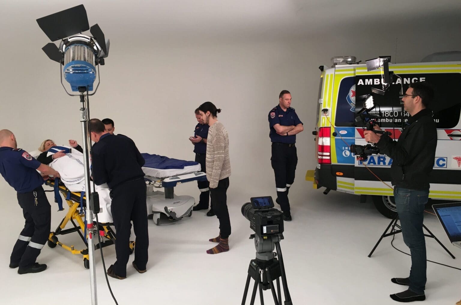 Dream Engine filming Stryker stretcher training with ambulance personnel in a white cyclorama studio