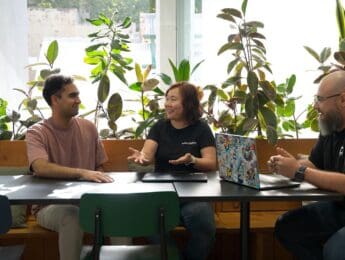 Three SafetyCulture data team members discussing a project in their office