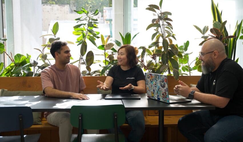 Three SafetyCulture data team members discussing a project in their office