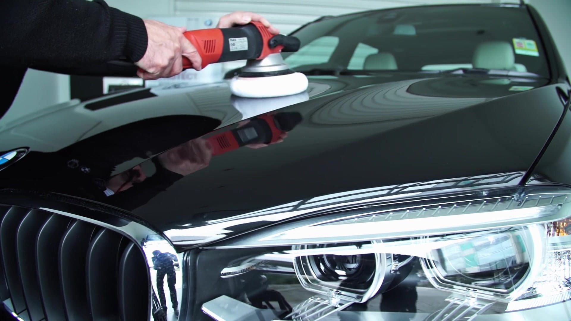 BMW vehicle bonnet being polished during a Seal and Protect training demonstration
