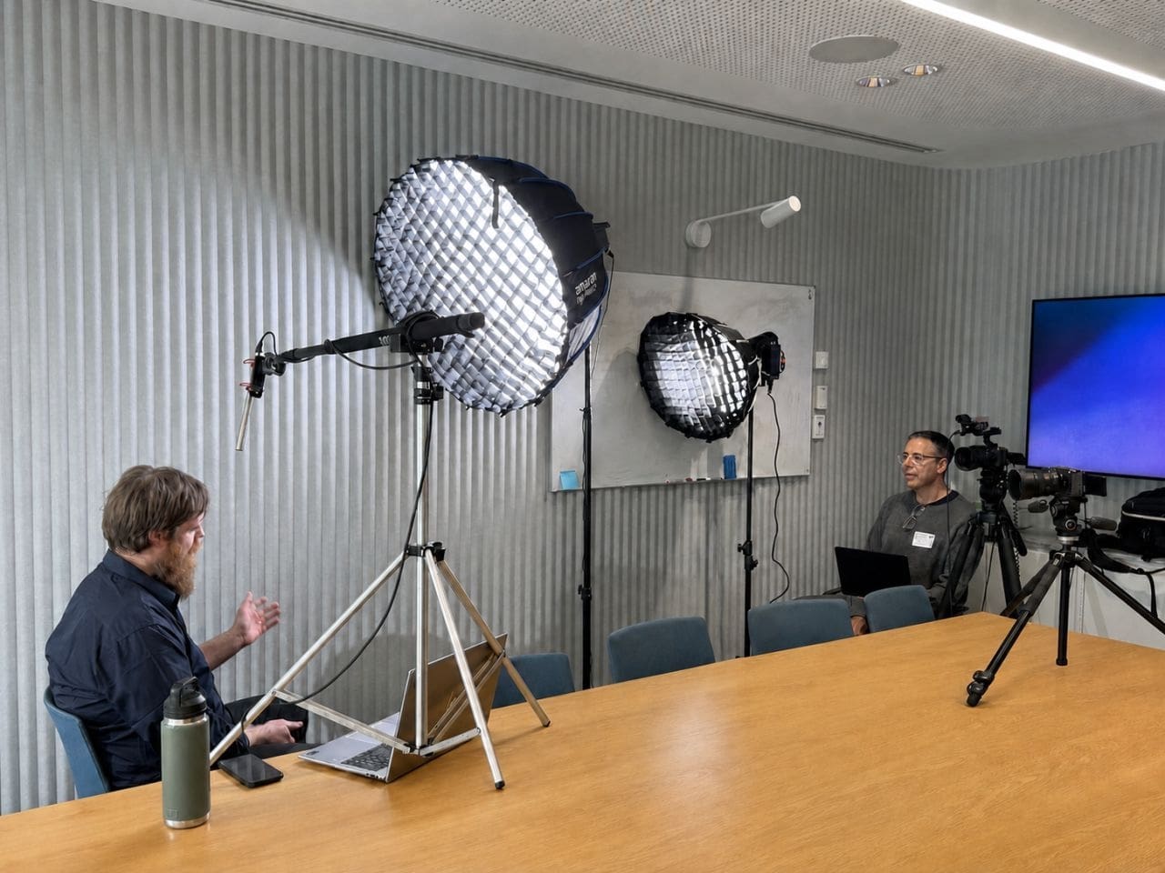 Dream Engine producer listening beside the camera while directing an interview