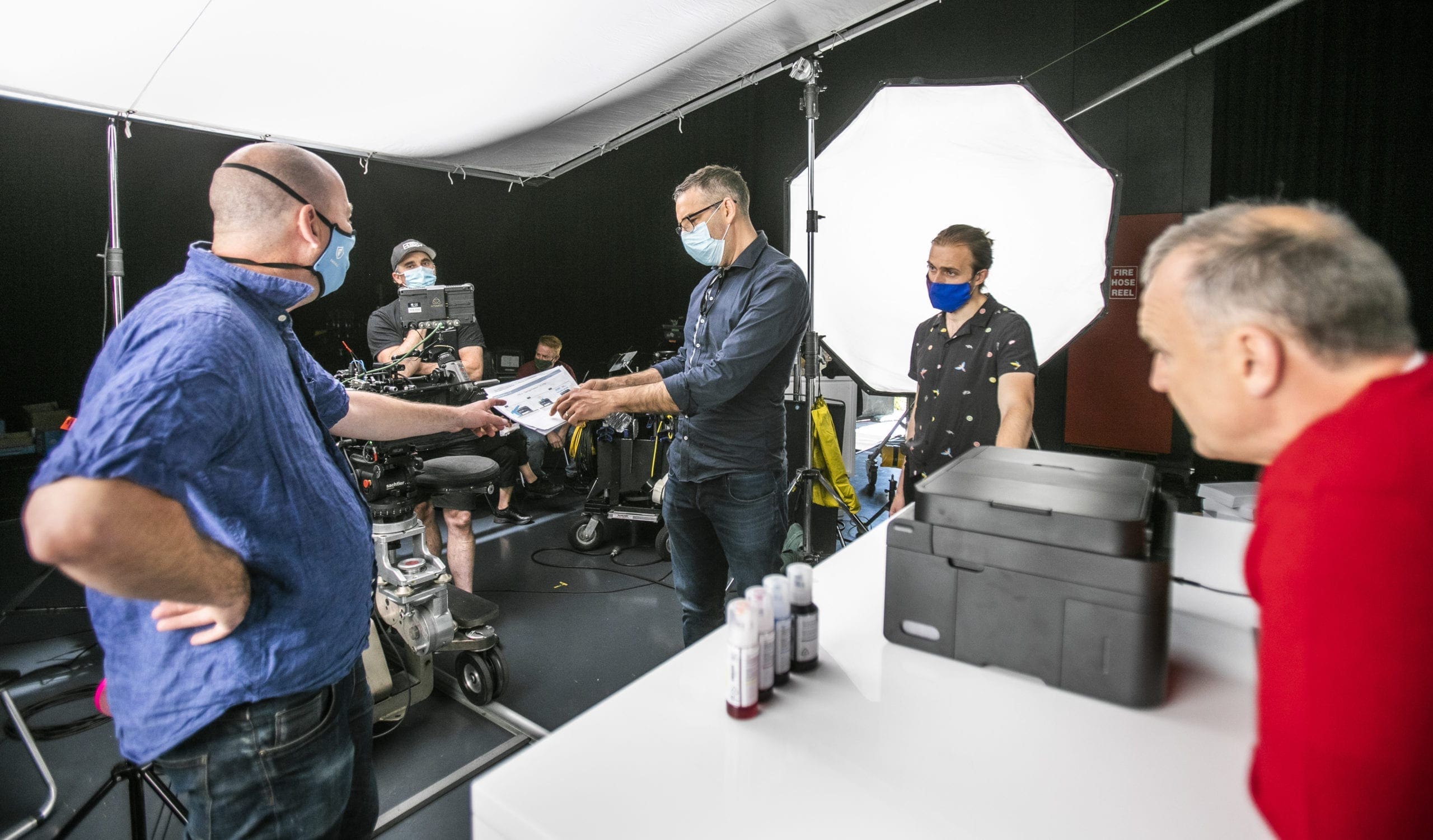 Dream Engine crew reviewing storyboard material on the Epson EcoTank television commercial set