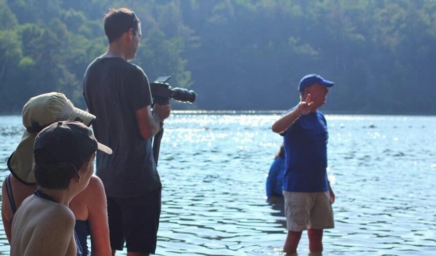 Dream Engine crew filming an interview beside a lake