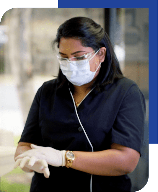 nurse in hospital putting on gloves