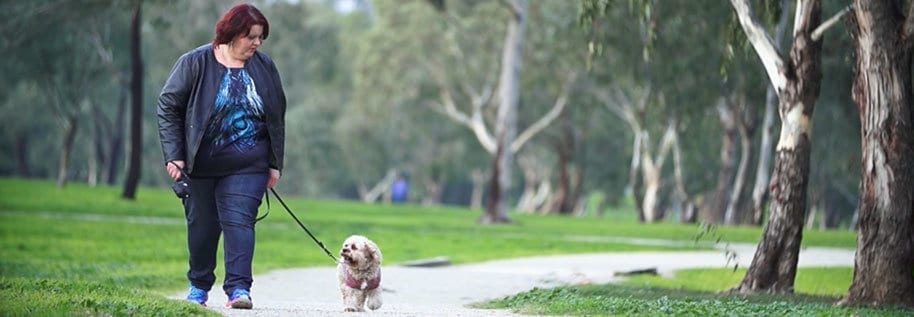 Woman walking dog in park